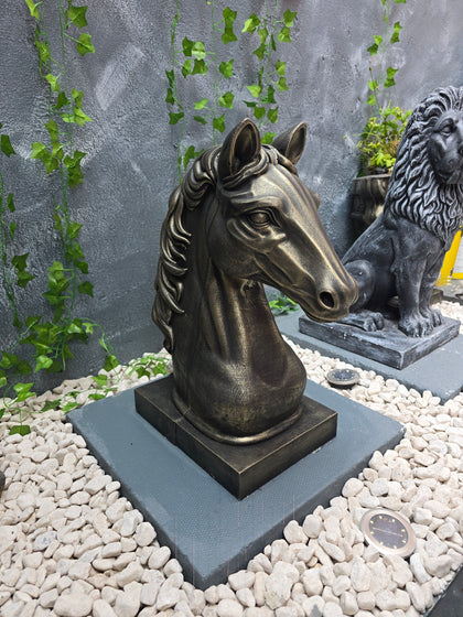 Side profile of decorative horse head concrete statue