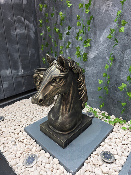 Premium concrete horse bust statue with black and gold finish displayed in garden setting